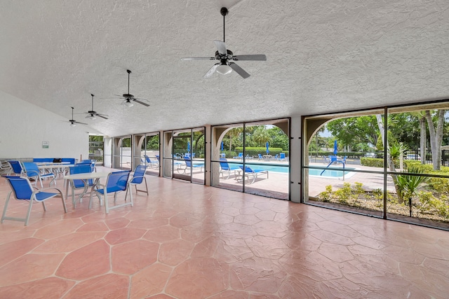 sunroom featuring ceiling fan and a healthy amount of sunlight