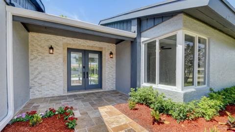 property entrance featuring a patio and french doors