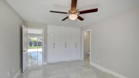 unfurnished bedroom featuring ceiling fan and light tile floors