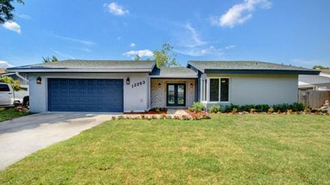 ranch-style house featuring a front yard and a garage