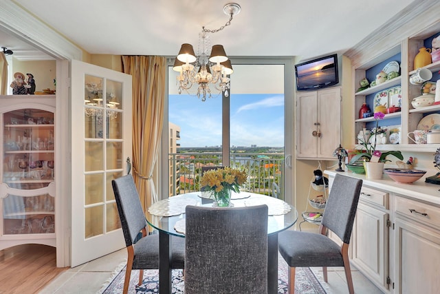 tiled dining area featuring an inviting chandelier