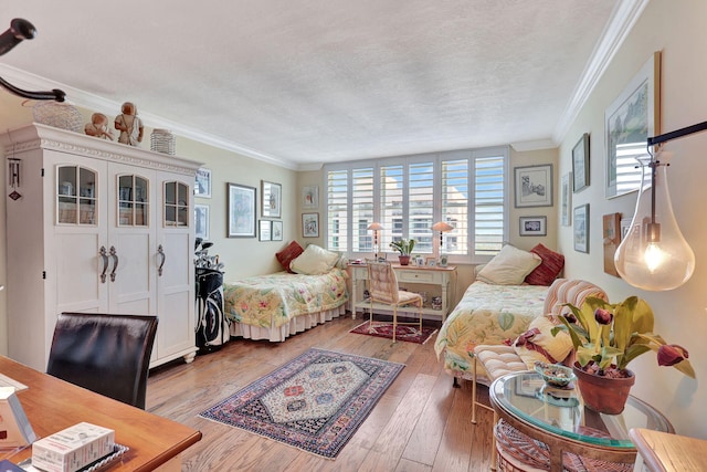 living room featuring a textured ceiling, ornamental molding, and hardwood / wood-style floors