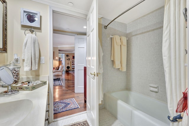 bathroom with wood-type flooring, ornamental molding, and shower / tub combo with curtain