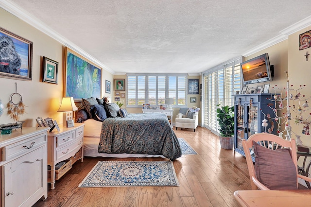 bedroom with floor to ceiling windows, light hardwood / wood-style flooring, a textured ceiling, and crown molding