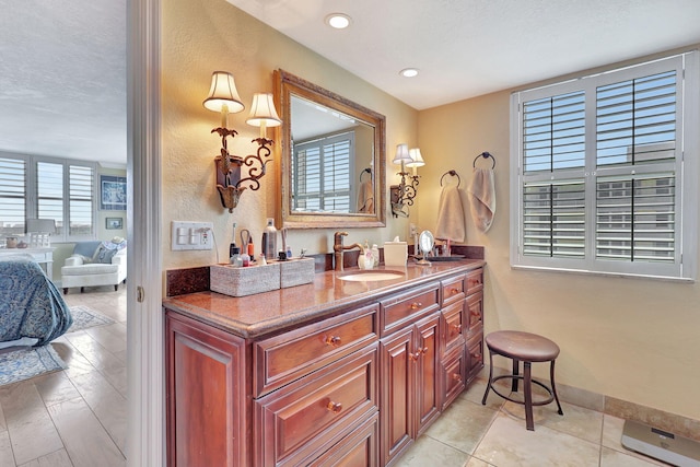 bathroom with a textured ceiling and vanity