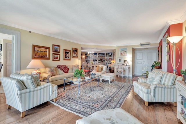 living room featuring crown molding and hardwood / wood-style floors