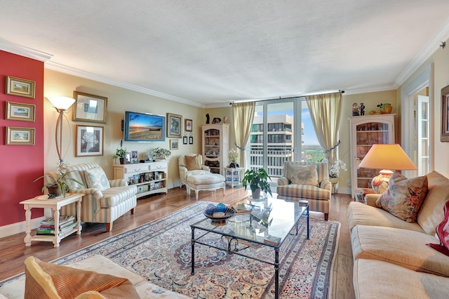 living room with crown molding and hardwood / wood-style flooring