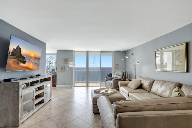 tiled living room featuring floor to ceiling windows