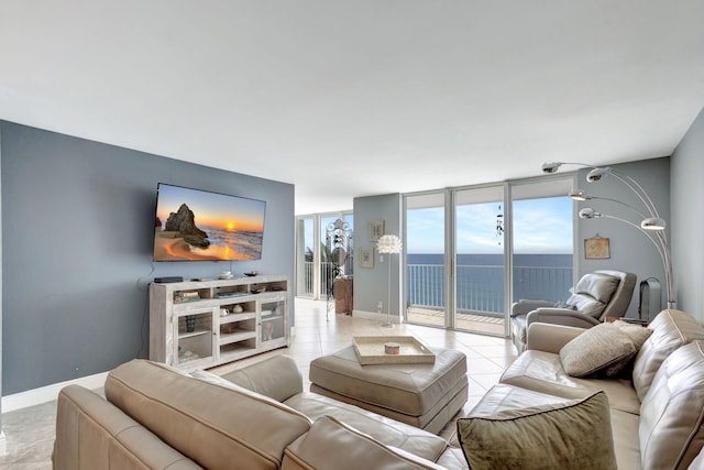 tiled living room with a water view and a wall of windows