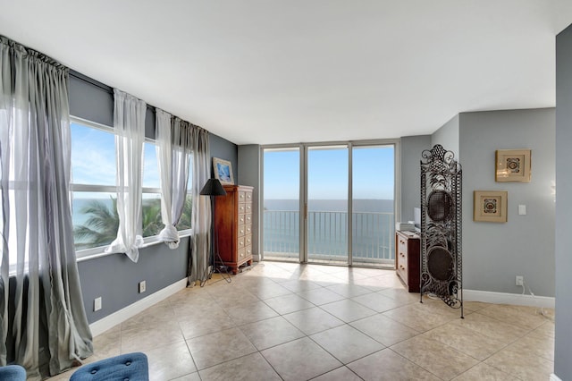 living room with a water view and light tile floors