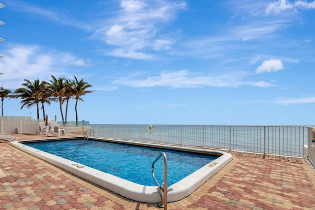 view of swimming pool featuring a patio area