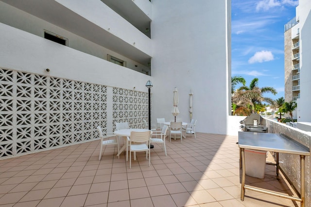 view of terrace with exterior kitchen and a balcony