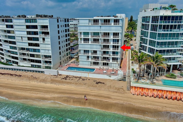 view of property with a view of the beach and a water view