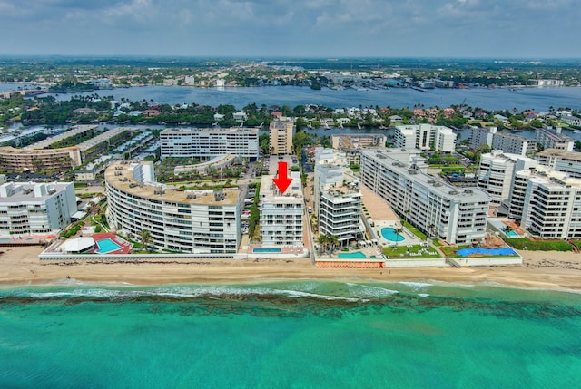 birds eye view of property with a beach view and a water view