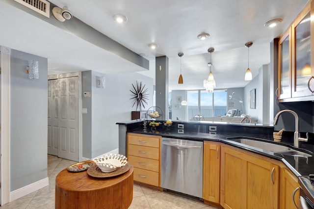 kitchen featuring sink, dishwasher, decorative light fixtures, and light tile floors