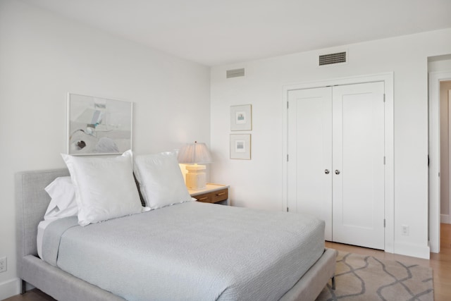 bedroom featuring wood-type flooring and a closet