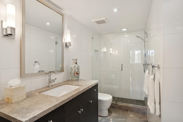 bathroom with vanity, toilet, and an enclosed shower