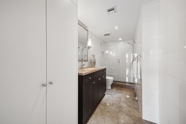 bathroom with vanity, toilet, and walk in shower