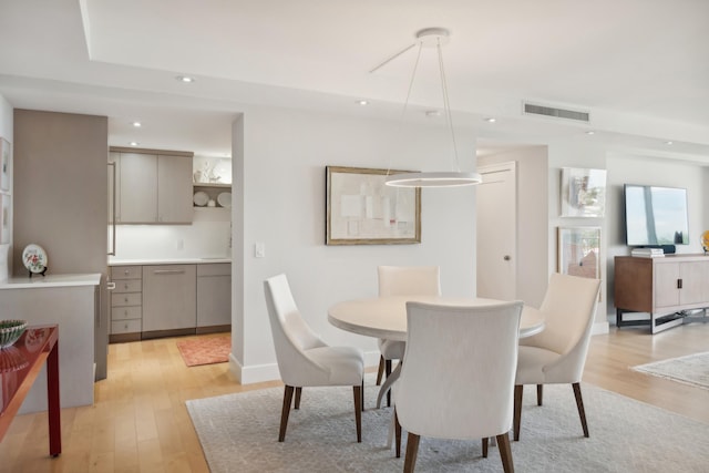 dining space with light hardwood / wood-style floors