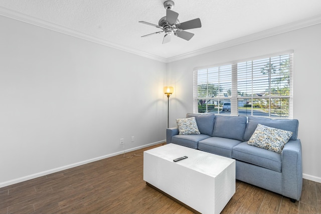 living room with ornamental molding, dark wood-type flooring, ceiling fan, and a textured ceiling