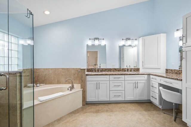 bathroom featuring tile patterned flooring, vanity, and shower with separate bathtub