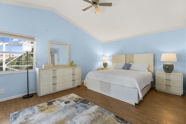 bedroom with vaulted ceiling, dark wood-type flooring, crown molding, and ceiling fan