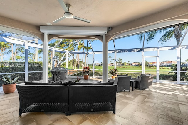 sunroom / solarium featuring ceiling fan and plenty of natural light