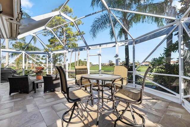 sunroom featuring ceiling fan and a wealth of natural light