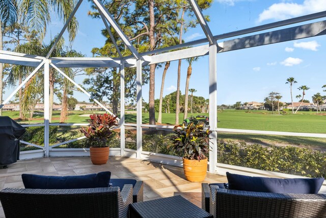 view of patio featuring glass enclosure