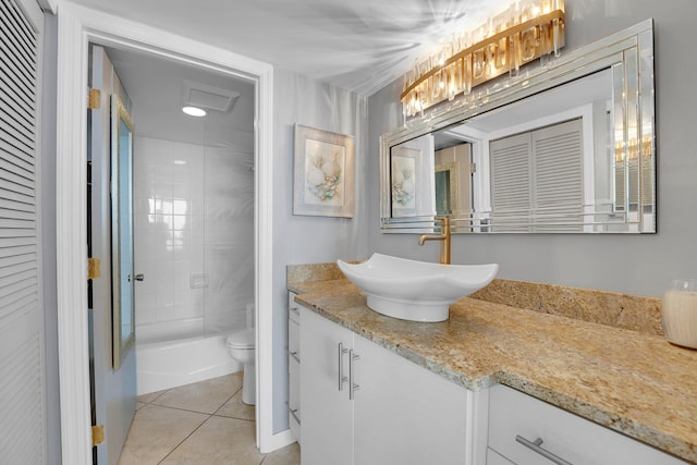 full bathroom featuring vanity, tiled shower / bath, tile patterned flooring, and toilet