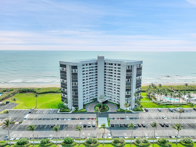 birds eye view of property with a water view and a view of the beach