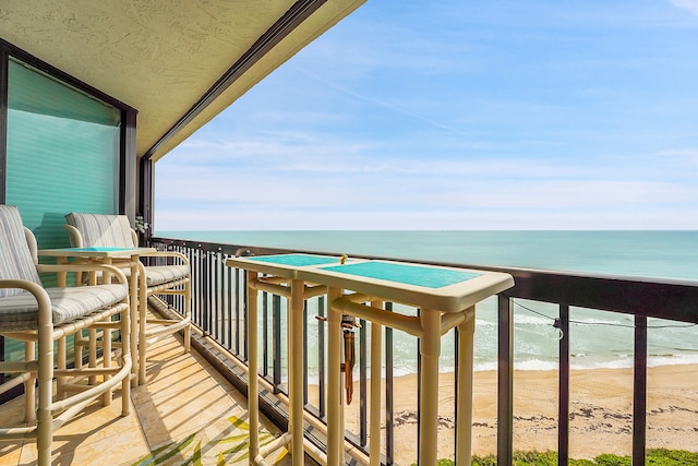 balcony with a beach view and a water view