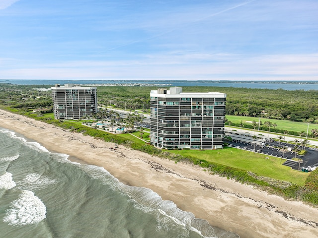 aerial view with a water view and a view of the beach