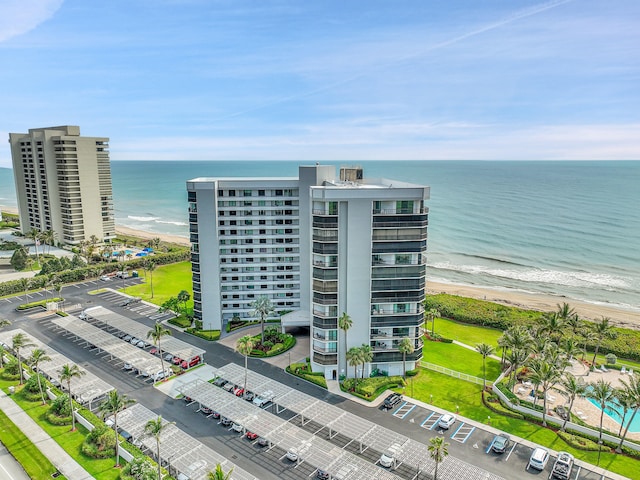 birds eye view of property featuring a water view and a view of the beach