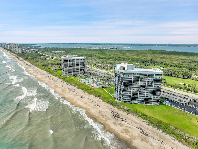 aerial view with a water view and a beach view