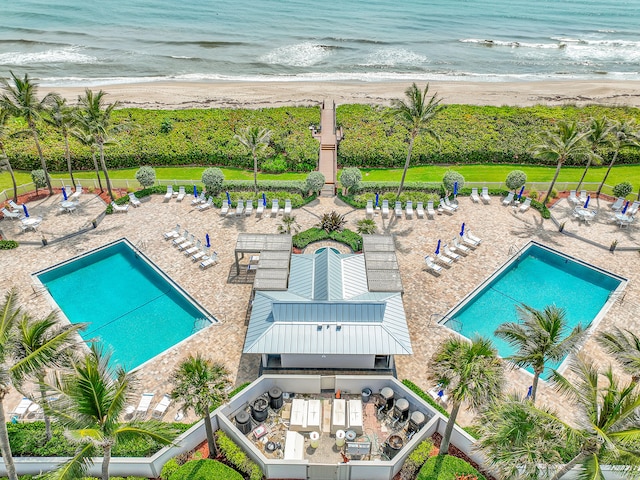 view of swimming pool with a view of the beach and a water view