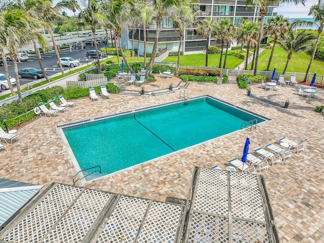 view of pool featuring a yard and a patio area