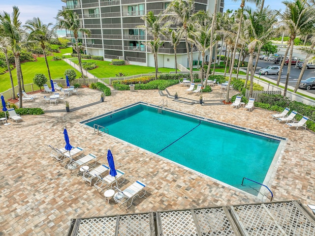 view of pool with a patio area and a yard