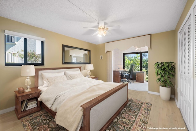 bedroom featuring hardwood / wood-style floors, ceiling fan, and a textured ceiling