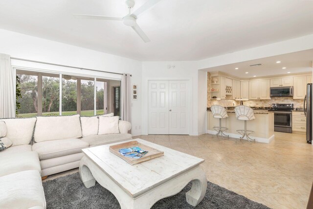 tiled living room with ceiling fan