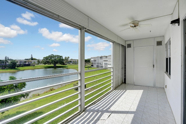 balcony with ceiling fan and a water view