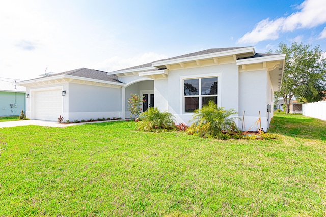 view of front facade with a garage and a front lawn