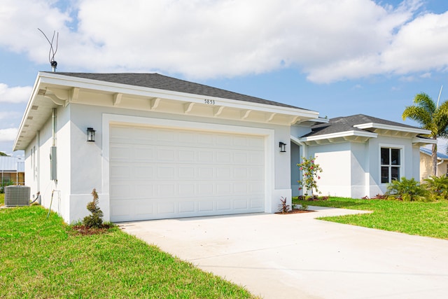 ranch-style house featuring a front yard, a garage, and central AC