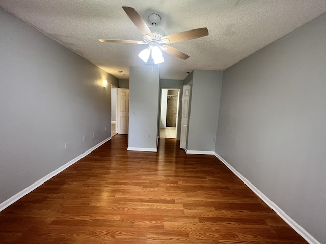 unfurnished bedroom featuring ceiling fan, a textured ceiling, and hardwood / wood-style flooring