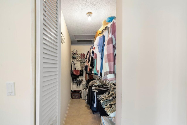 spacious closet with light tile patterned flooring