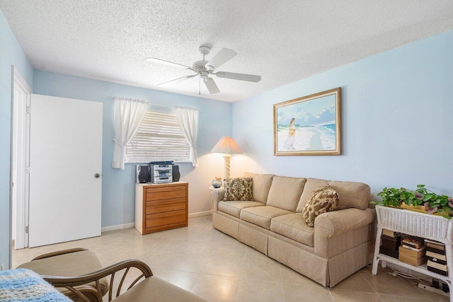 living room featuring ceiling fan and a textured ceiling