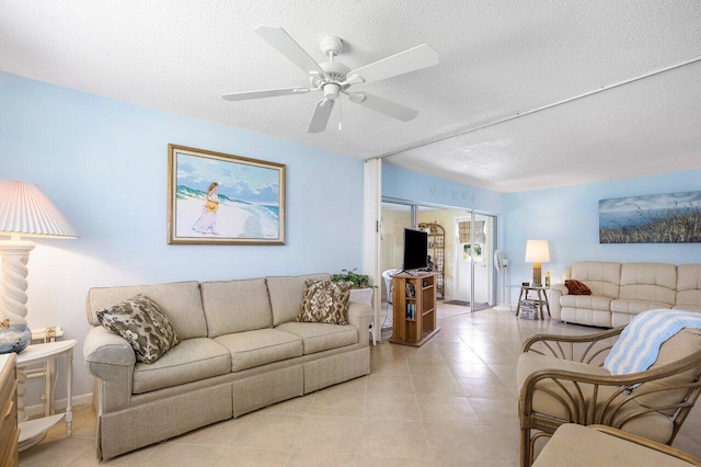 tiled living room featuring ceiling fan and a textured ceiling