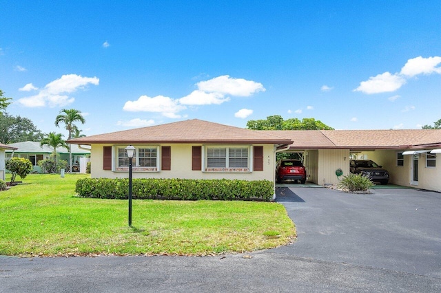 ranch-style home with a front lawn and a carport