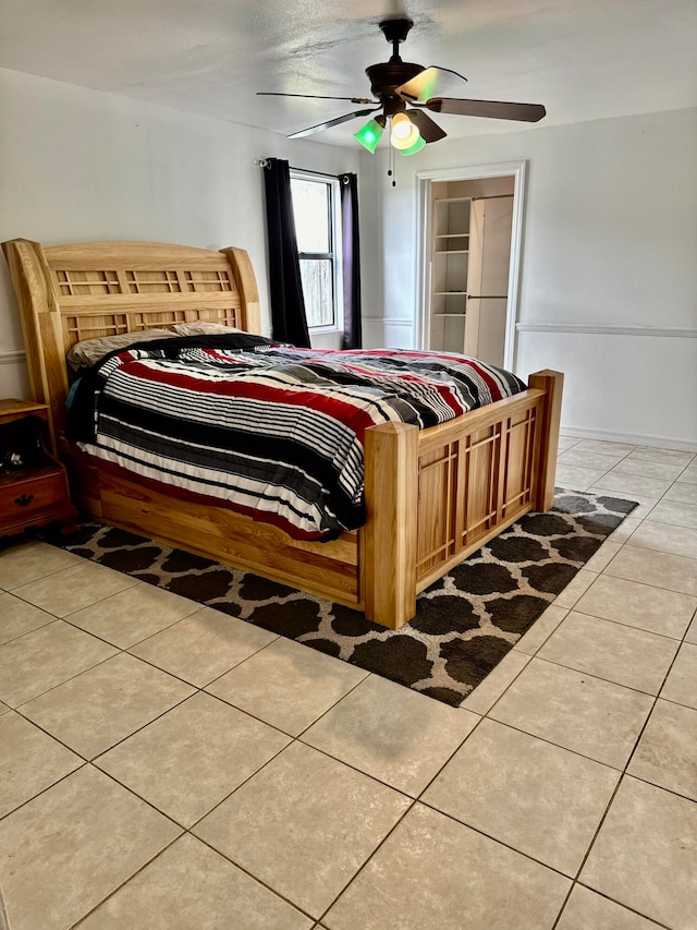 bedroom featuring light tile patterned floors and ceiling fan