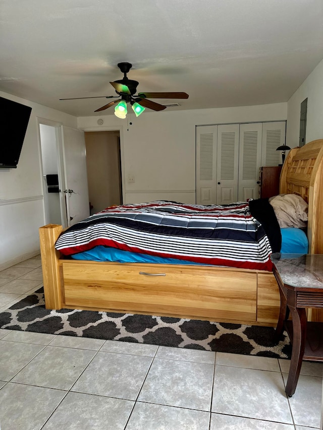 tiled bedroom featuring a closet and ceiling fan